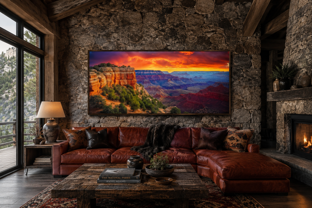 Framed panoramic canvas print of a vibrant Grand Canyon sunset hanging above a leather sofa.