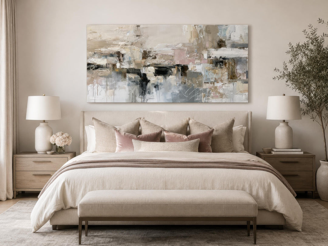 Horizontal abstract canvas print with gray, beige, and blush brushstrokes above a neutral bed.