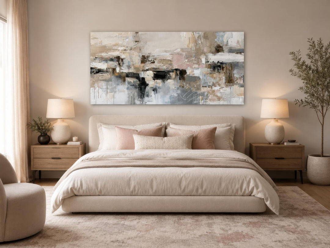 Gray, beige, and blush neutral abstract horizontal canvas print hanging above a bed in a bedroom.