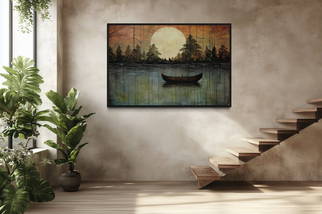 Framed canvas wall art of a boat on a lake under a full moon, hung in a modern rustic room.