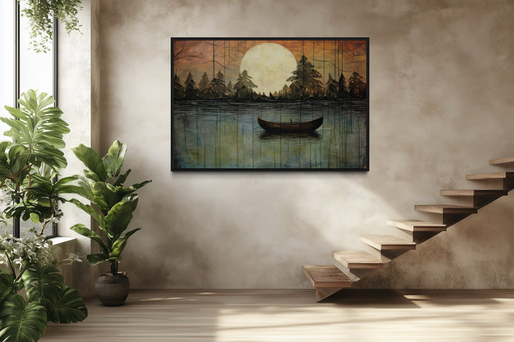 Framed canvas wall art of a boat on a lake under a full moon, hung in a modern rustic room.