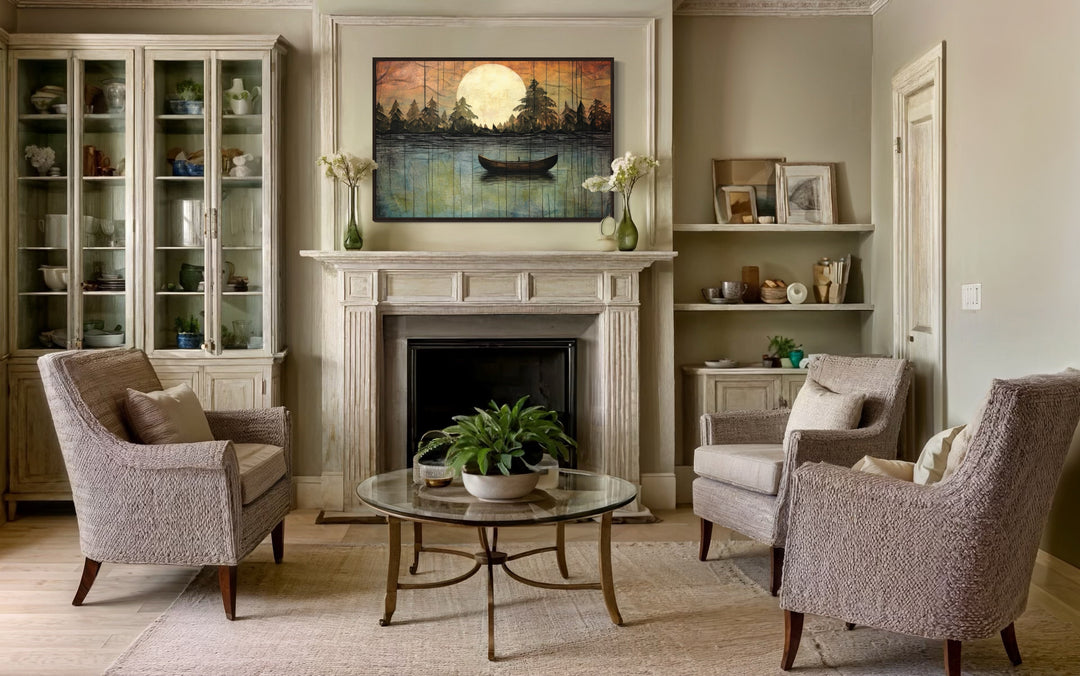 Framed canvas wall art of a moonlit lake with a boat, hanging above a fireplace in a living room.