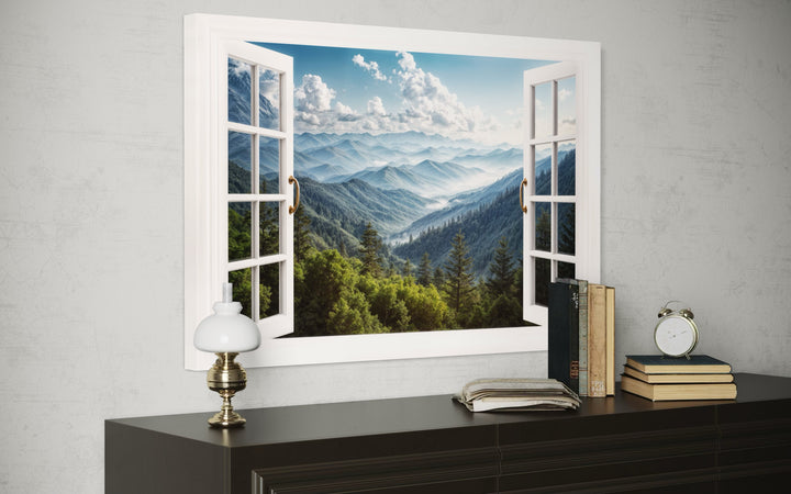 Great Smokey Mountains view painting in a white faux window frame on a gray wall above a dresser.