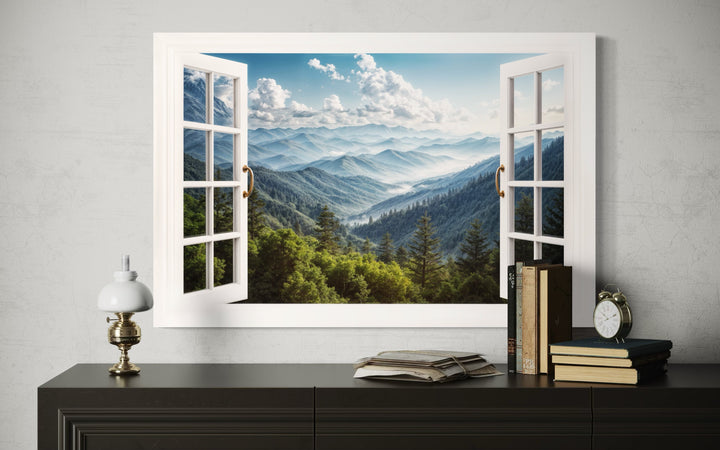 Great Smokey Mountains view painting in a faux open window frame on a wall above a dark sideboard.