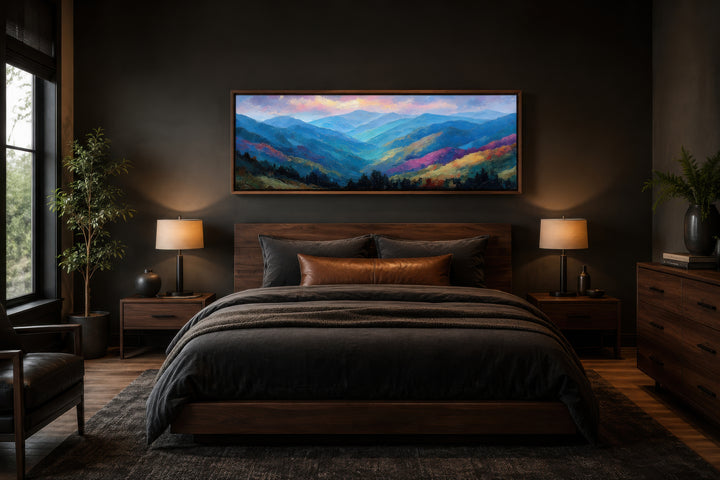 Long horizontal canvas art of the Smoky Mountains at sunset above a bed in a dark modern bedroom.