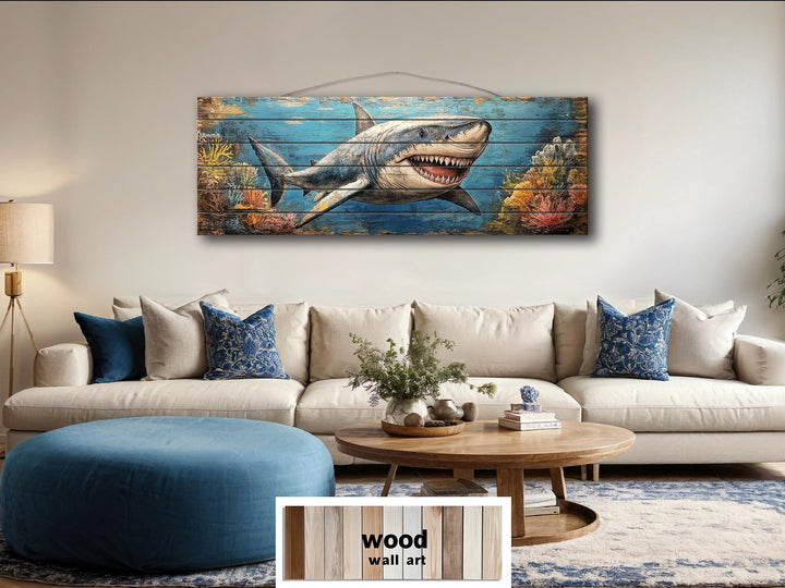 A horizontal distressed wood wall art piece featuring a great white shark swimming through a reef.