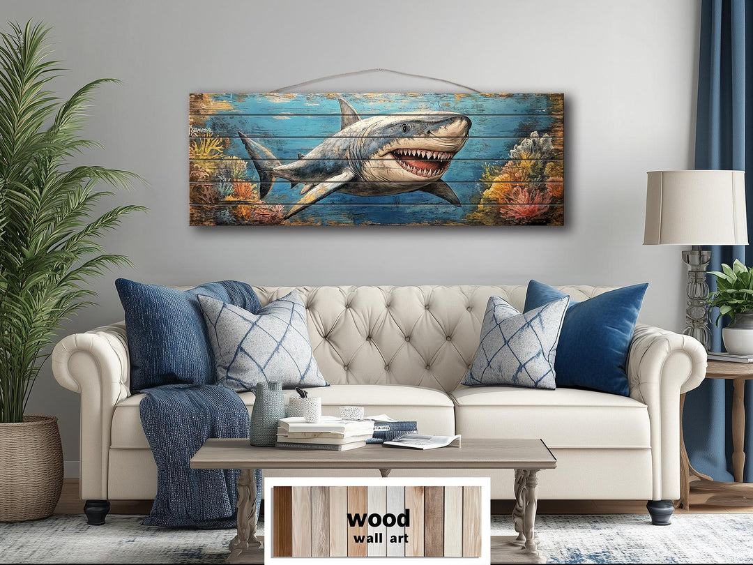 Horizontal wood wall art featuring a great white shark swimming through a colorful coral reef.