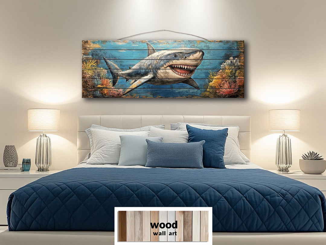 Horizontal distressed wood wall art of a great white shark swimming through a coral reef.