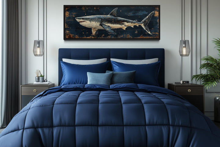 Great white shark horizontal canvas wall art above a navy blue bed in a modern bedroom.