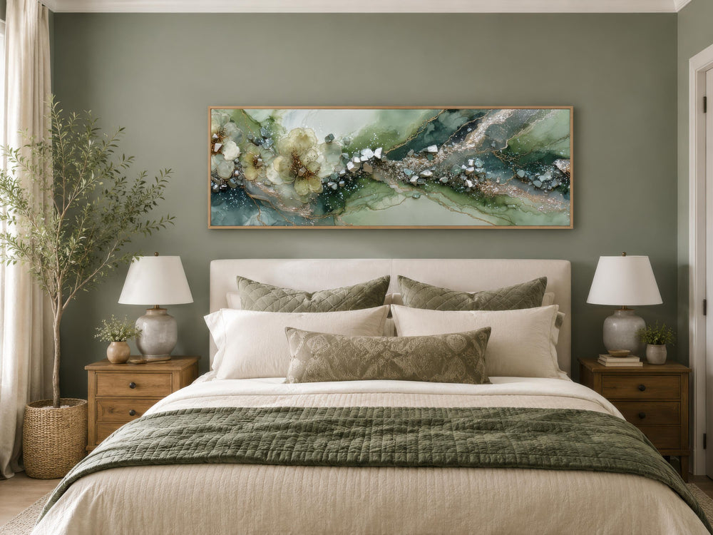 Long horizontal sage green geode canvas print with floral accents above a bed in a modern bedroom.