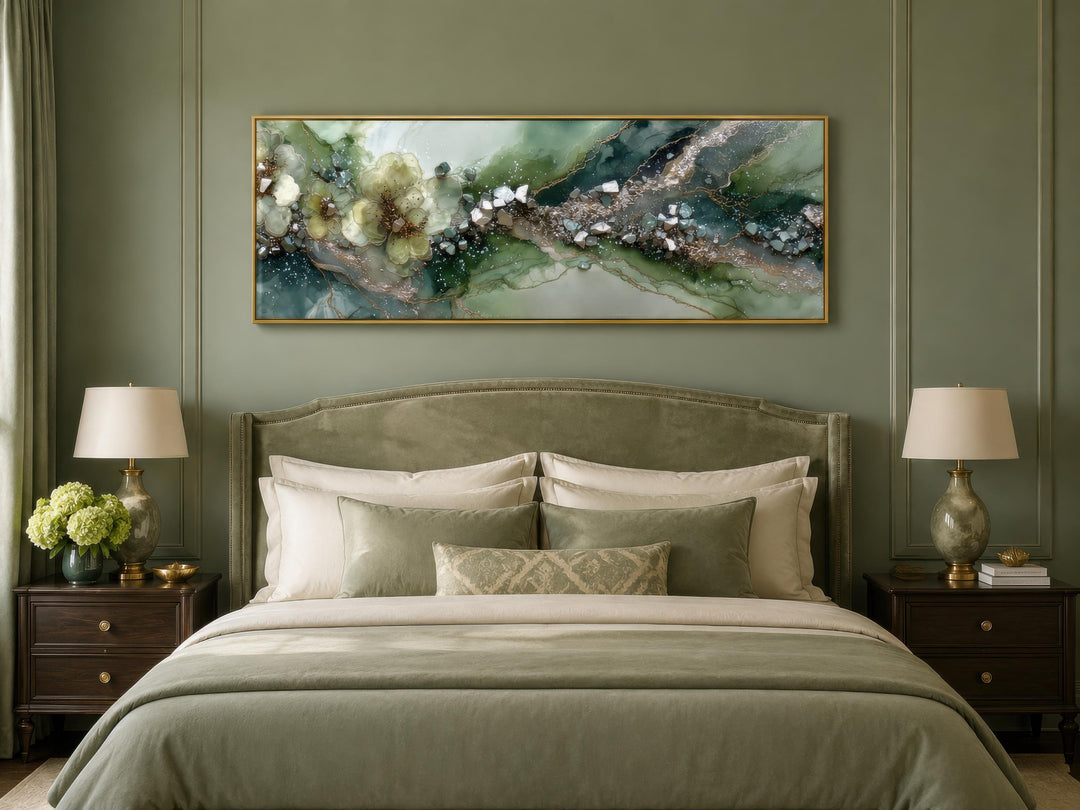 Long horizontal sage green geode canvas print with floral accents above a bed in a green bedroom.