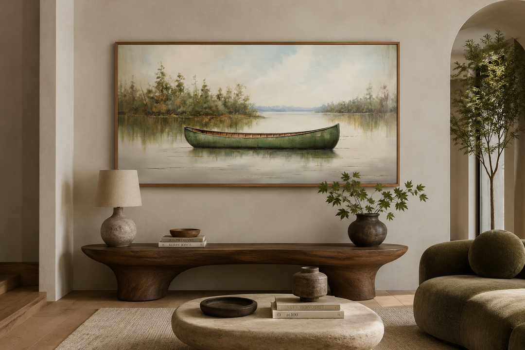 Framed canvas painting of a green canoe on a calm lake, styled in a rustic living room.