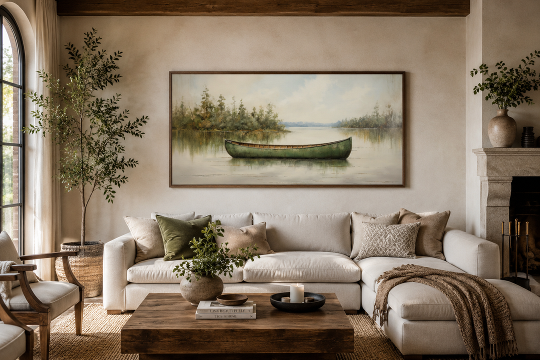 Framed canvas painting of a green canoe on a calm lake, styled in a rustic living room.