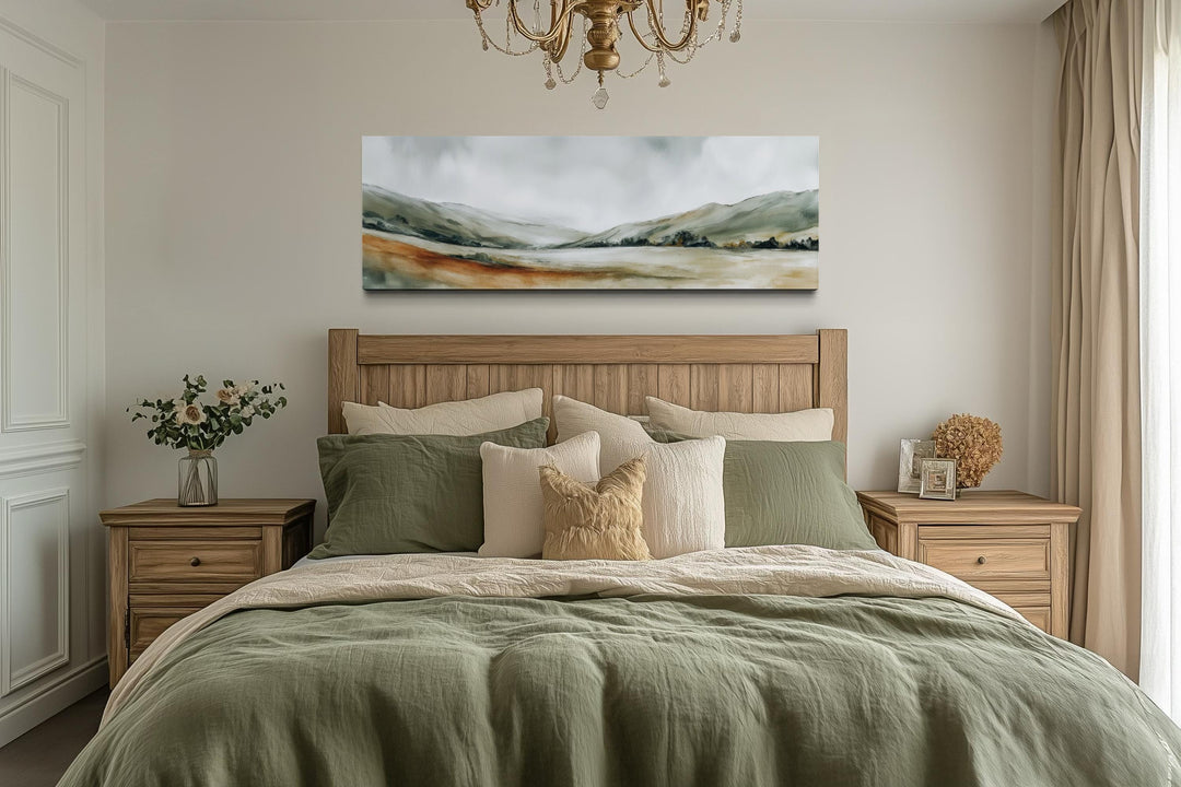 A panoramic canvas print of a minimalist sage green landscape hangs above a wooden bed frame.