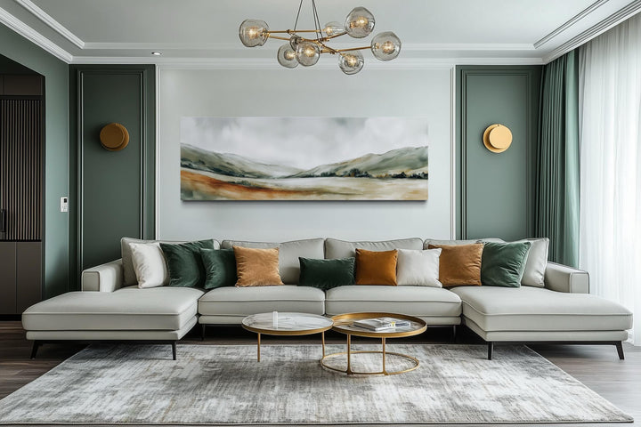 Panoramic green landscape wall art canvas print above a modern sofa in a minimalist living room.