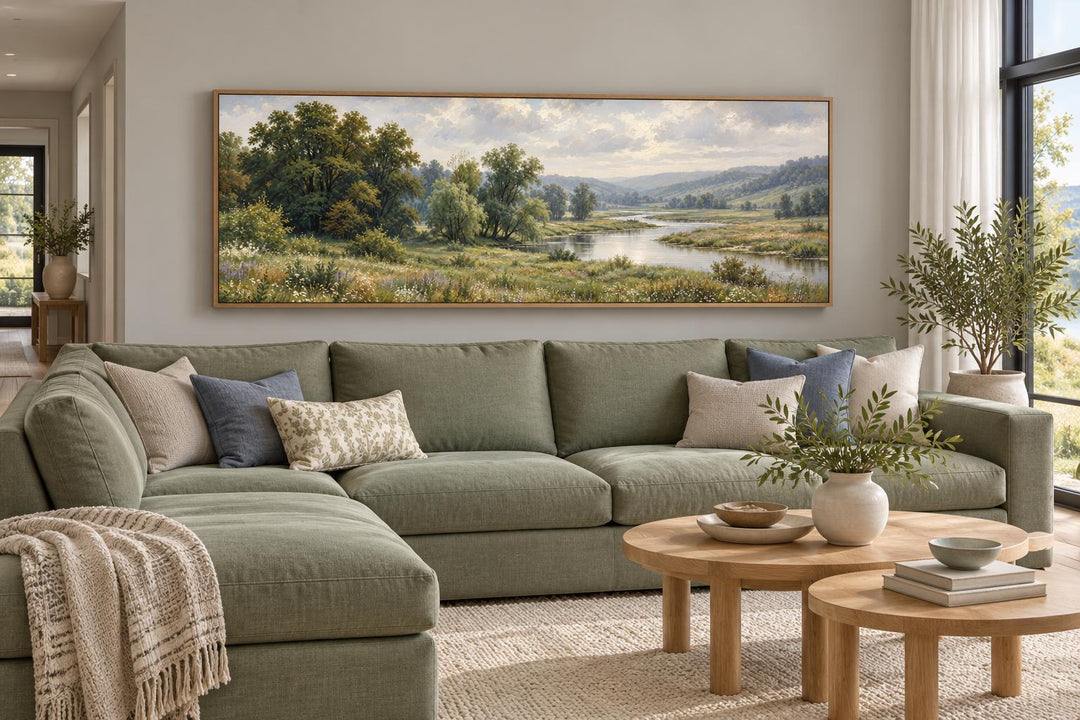Green Valley and River Landscape long horizontal canvas wall art above a green sectional sofa.