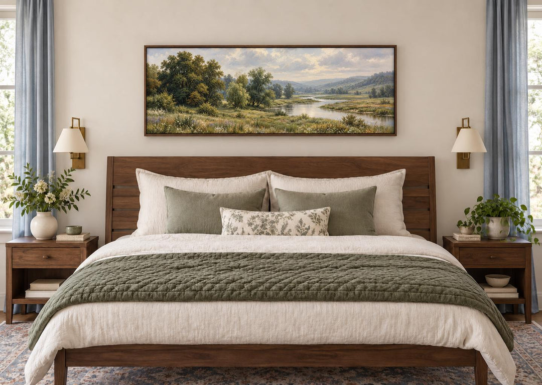 Green Valley and River Landscape long horizontal canvas wall art hanging above a wooden bed frame.