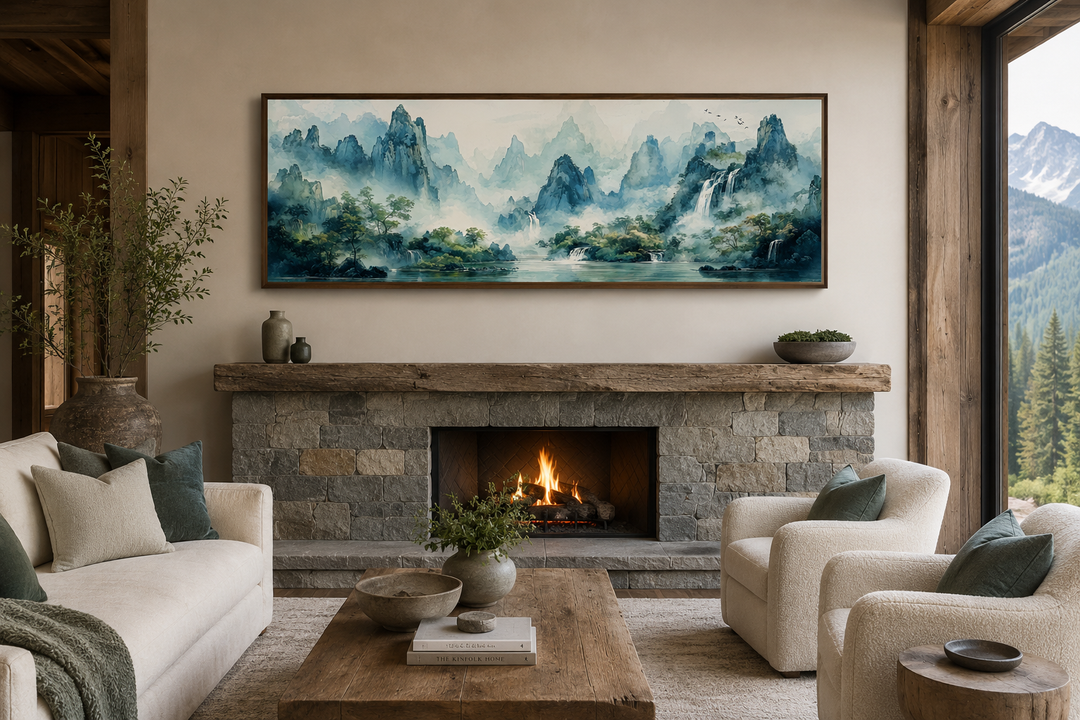 Green Shan Shui long narrow landscape canvas wall art above a stone fireplace in a rustic room.