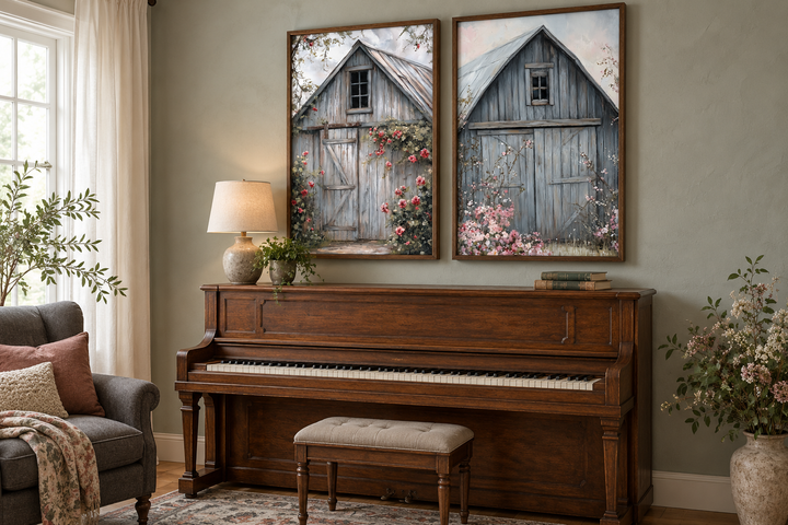 Two framed canvas paintings of rustic grey barn doors with pink flowers above a wooden piano.
