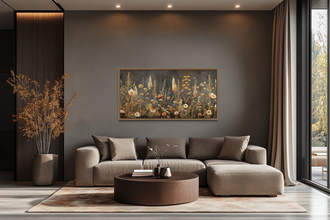 Grey beige boho wildflowers field framed canvas wall art hanging above a modern sectional sofa.