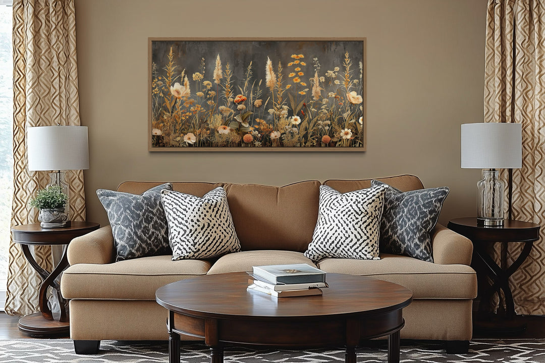 Grey Beige Boho Wildflowers Field Framed Canvas Wall Art hanging above a tan sofa in a living room.
