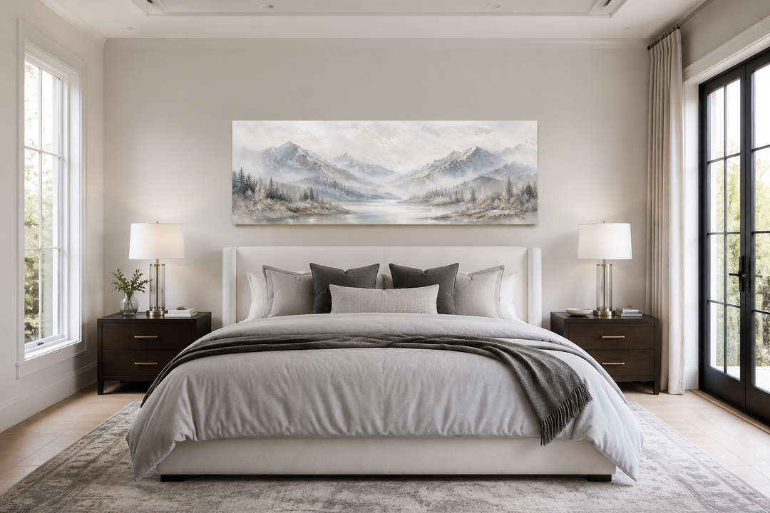 Minimalist abstract mountain horizontal wall art in grey, silver, and white hanging over a bed.