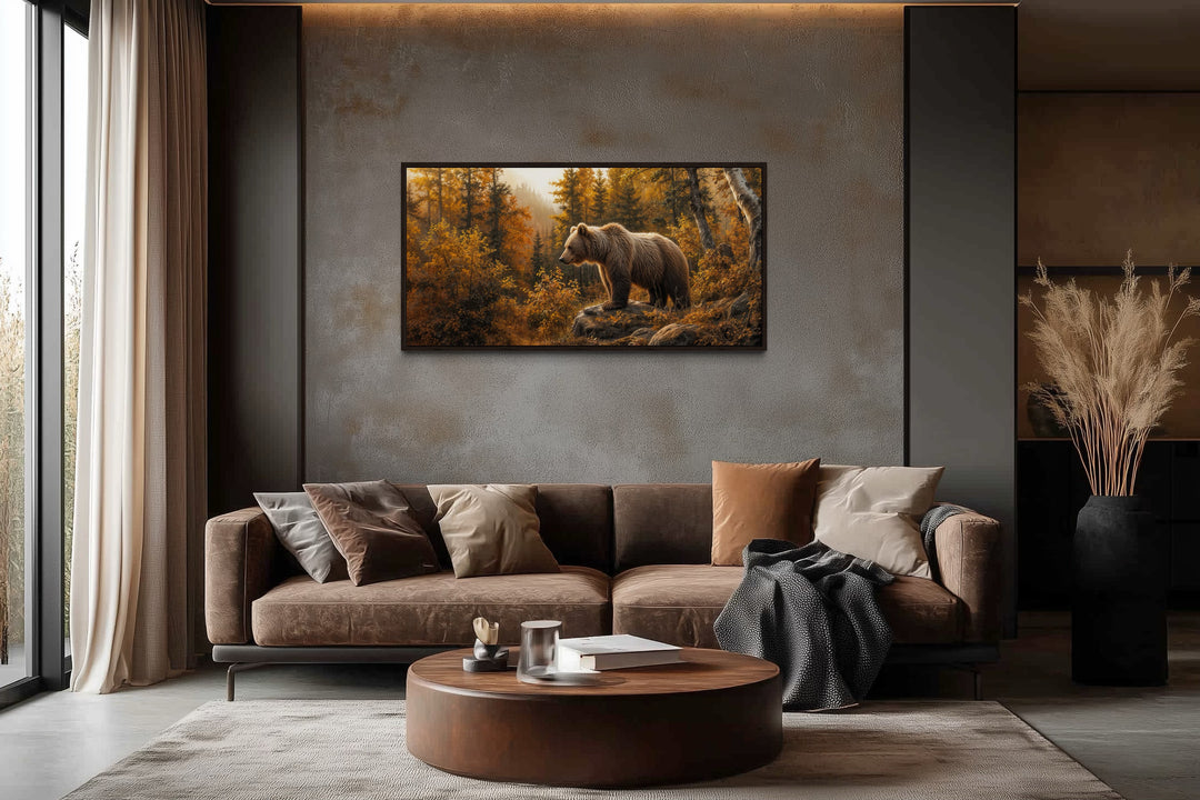 Grizzly bear in autumn forest photo-style canvas wall art hanging above a brown sofa in a cabin.