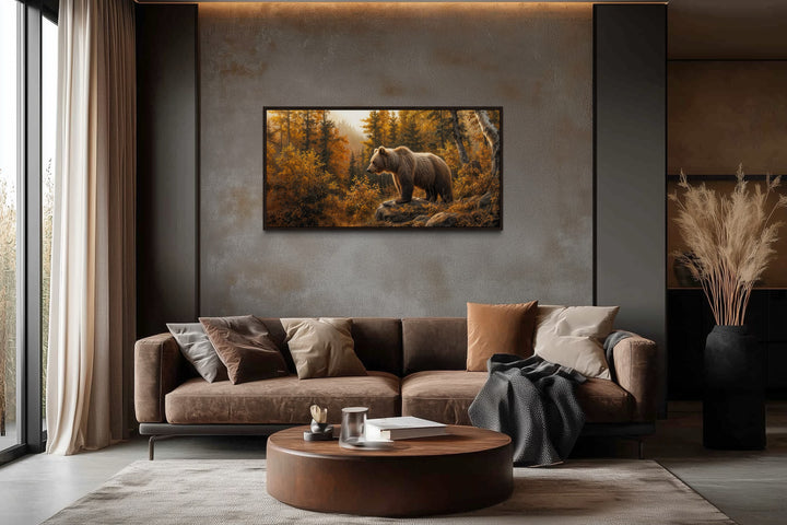 Grizzly bear in autumn forest photo-style canvas wall art hanging above a brown sofa in a cabin.