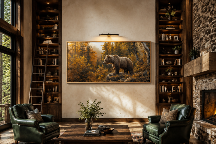 Framed canvas wall art of a grizzly bear in a golden autumn forest, hanging in a rustic living room.