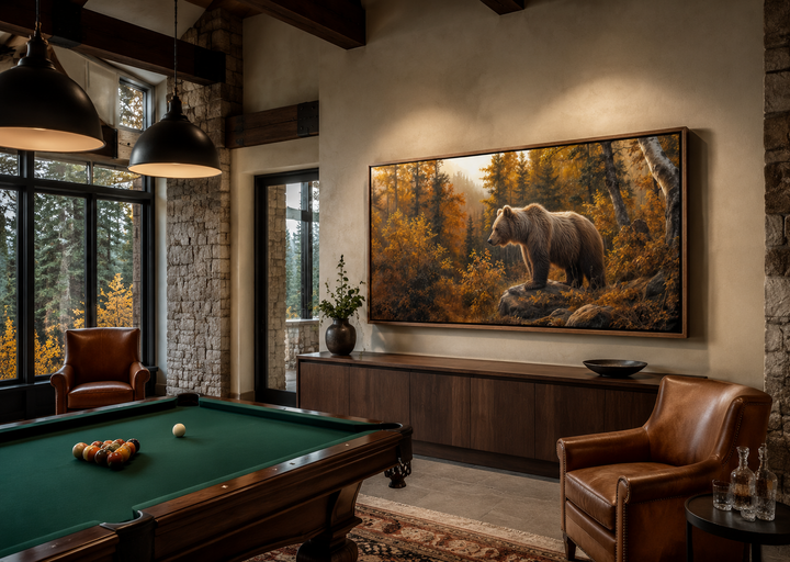 Framed canvas wall art of a grizzly bear in a golden autumn forest, hung in a rustic cabin room.
