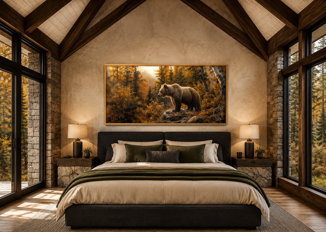 Framed canvas wall art of a grizzly bear in a golden autumn forest above a bed in a rustic cabin.