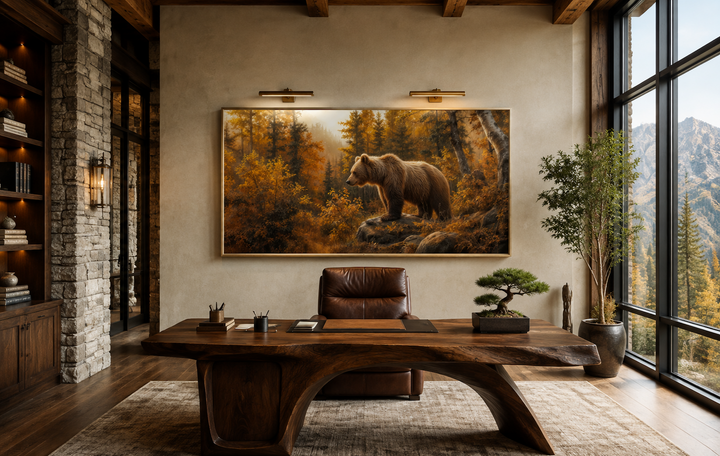 Framed canvas wall art of a grizzly bear in a golden autumn forest, hanging in a rustic office.