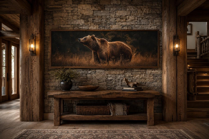 Grizzly bear horizontal canvas print on a stone wall above a rustic wooden console table.