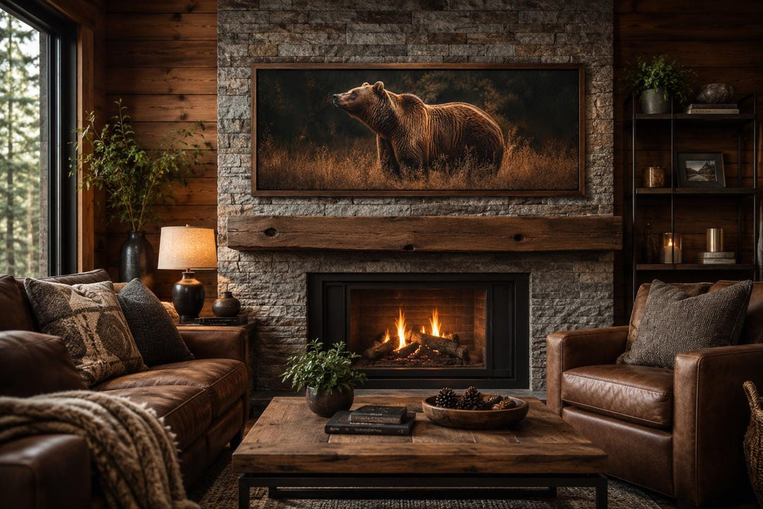 Grizzly bear in golden grass canvas print hanging above a rustic stone fireplace in a cabin.
