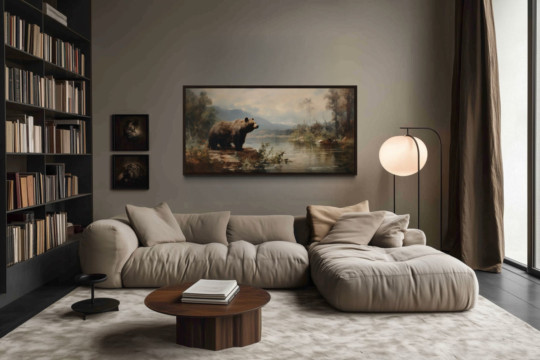 Framed grizzly bear canvas print hanging above a modern sofa in a rustic living room.