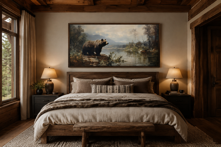 Framed grizzly bear canvas print hanging above a wooden bed in a rustic cabin bedroom.