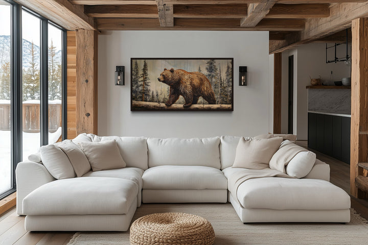 Rustic grizzly bear canvas wall art with wood effect framed above a white sectional sofa.