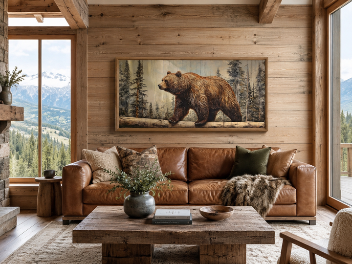 Rustic grizzly bear wall art on wood effect canvas hanging above a leather sofa in a cabin.