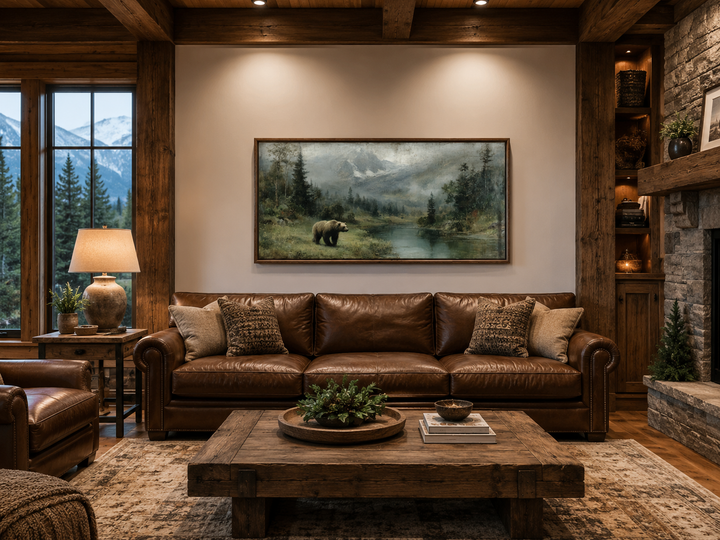 Grizzly bear on the lake rustic framed canvas wall art above a brown leather sofa in a cabin.