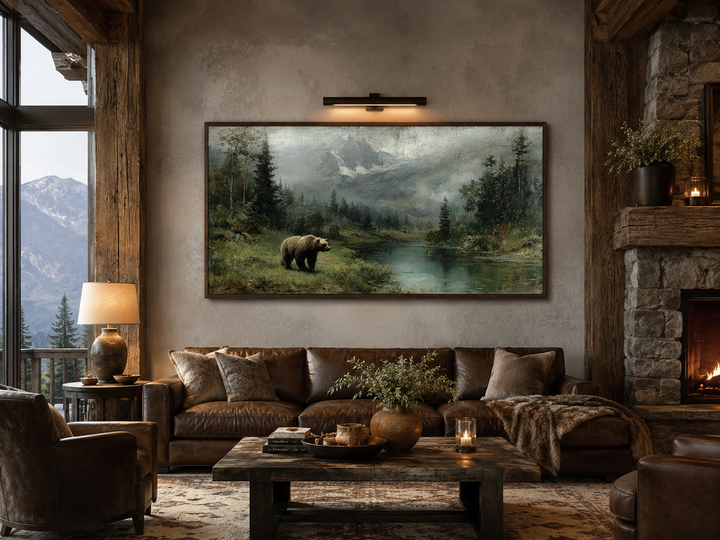Grizzly bear on the lake rustic framed canvas wall art above a brown leather sofa in a cabin.