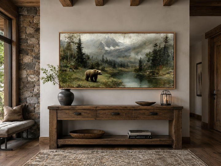 Grizzly bear on the lake rustic framed canvas wall art above a wooden console table in a cabin.