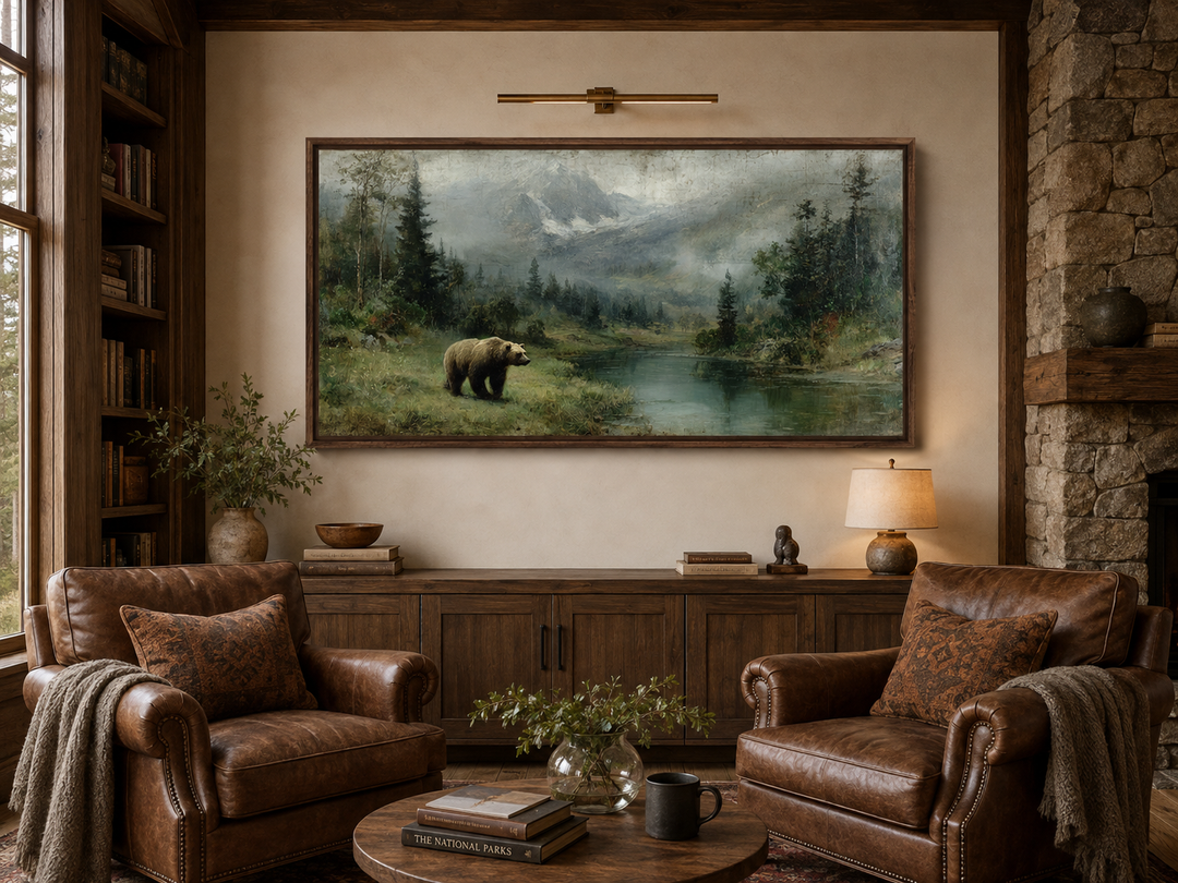 Grizzly bear walking by a mountain lake in a rustic framed canvas wall art above a wooden sideboard.