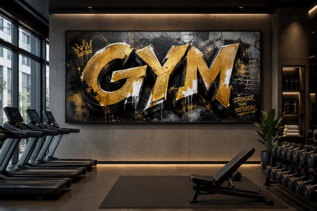 Gold graffiti GYM wall art with Stronger Than Yesterday text in a modern industrial home gym.