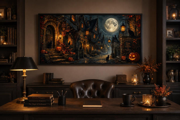 Gothic Halloween village canvas art with black cats, pumpkins, and a full moon above a dark desk.