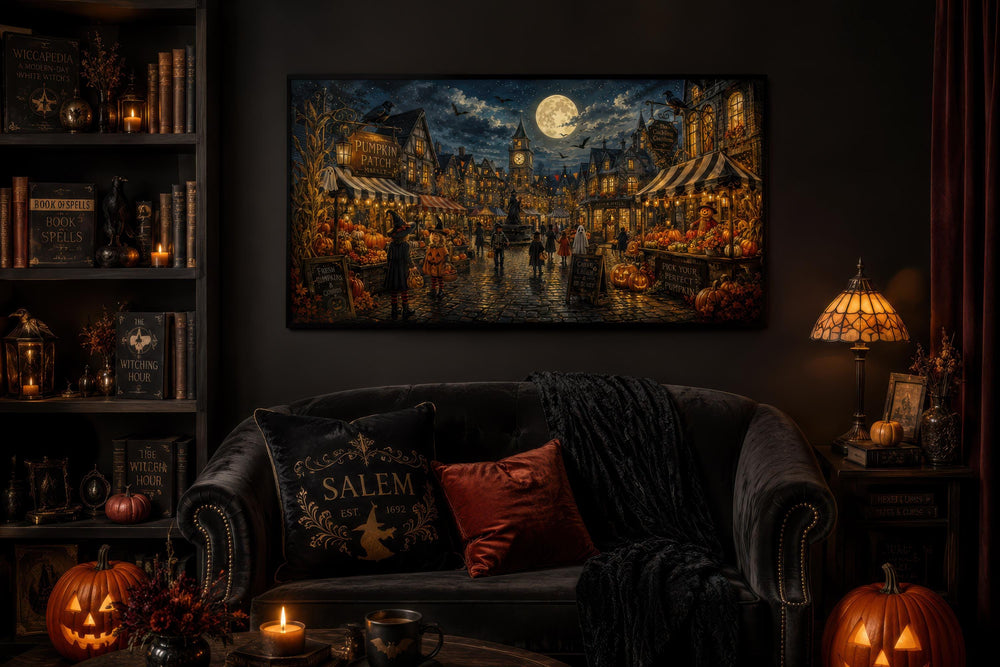 Halloween Village canvas print above a dark sofa with pumpkins, books, and a lamp in a cozy room.