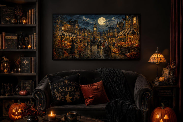 Halloween Village canvas print above a dark sofa with pumpkins, books, and a lamp in a cozy room.
