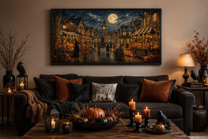 Halloween Village canvas print of trick-or-treating kids in a spooky town above a cozy sofa.