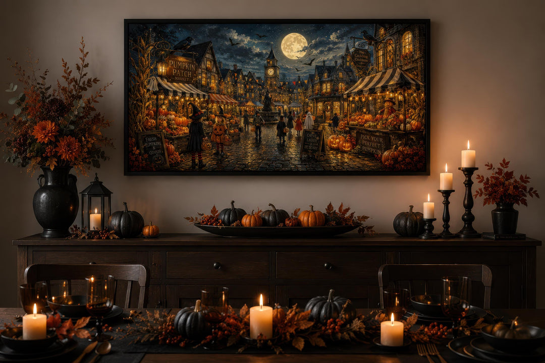 Halloween Village canvas print above a decorated sideboard with pumpkins and candles.
