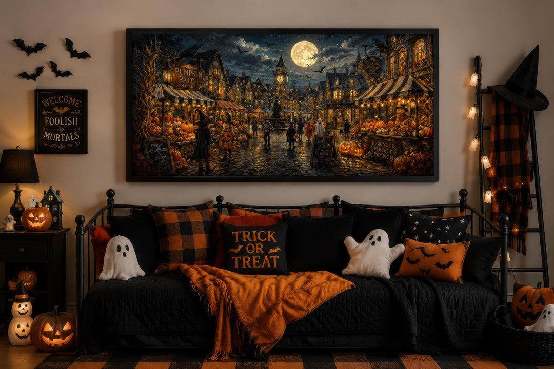 Halloween Village wall art canvas above a decorated daybed with ghost pillows and pumpkins.