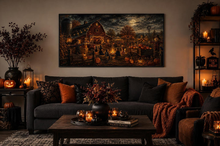 Harvest Festival canvas print above a dark sofa in a cozy, Halloween-themed living room.